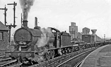 An ex-NER Class T2 0-8-0 No.63347 passes through Thornaby with a westward Class H train, consisting mainly of flat-wagons conveying steel slabs from Dorman Long. 28 March 1955, photo by Ben Brooksbank Thornaby railway station geograph-2865574-by-Ben-Brooksbank.jpg