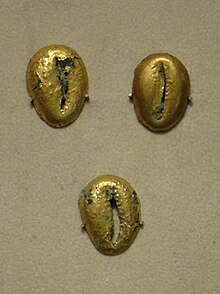 Three bronze coins covered with gold leaf on display at the China Numismatic Museum. Three Bronze Wampum Covered with Gold Leaf.jpg