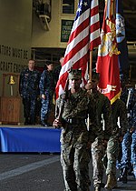 Thumbnail for File:U.S. Sailors and Marines assigned to the color guard parade the colors as part of a 9-11 remembrance ceremony in the hangar bay of the newly commissioned amphibious assault ship USS America (LHA 6) Sept 140911-N-CC789-042.jpg