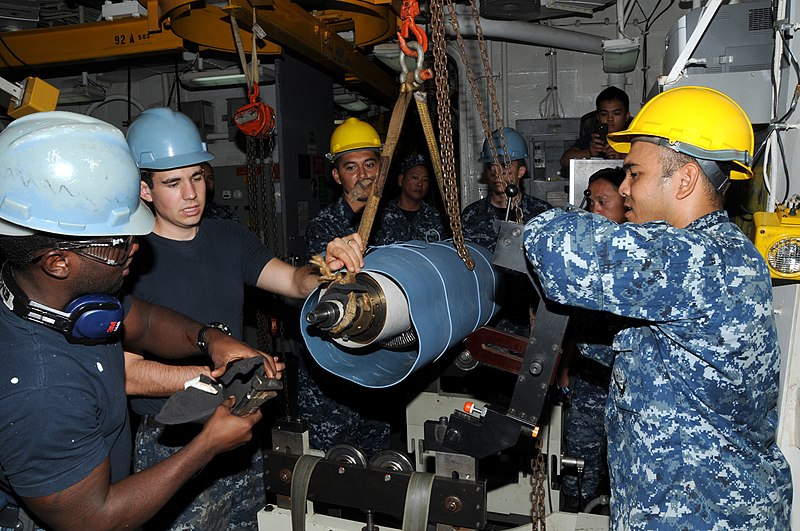 File:US Navy 111129-N-JB593-034 Sailors assigned to the submarine tender USS Frank Cable (AS 40) hoist a trim pump rotor onto the rotor balancing machin.jpg