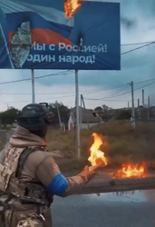 Member of the Kraken Regiment burning a pro-Russian billboard with a Molotov cocktail Ukrainian soldier of the Kraken Regiment in Kupiansk burning a pro-russian billboard with a Molotov Cocktail.png
