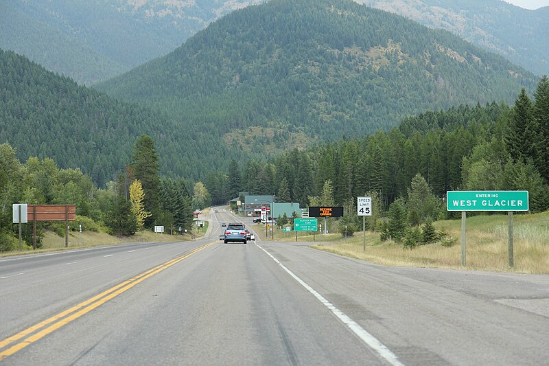 File:West Glacier Montana Sign looking east on US2.jpg