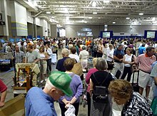 Antiques Roadshow appraises thousands of items in any given taping, with the public ticketed for time slots between 8 am and 5 pm local time; this image shows a portion of the public entering a July 2009 roadshow in Madison, Wisconsin, at noon. 2009-0711-AntiquesRoadshow04.jpg