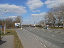 The A554 Bidston Link Road at Bidston Moss, looking towards Junction 1 of the M53. The lane on the left leads to Bidston Golf Club. Bidston Moss Retail Park is on the opposite side of the road.