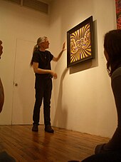 Grey in 2007 with one of his artworks Alex Grey Explaining.jpg