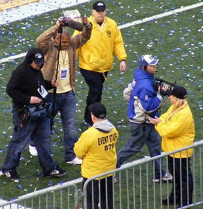 Antonio Pierce of the New York Giants holding up the Halas trophy