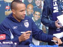 Thompson signing an autograph at a Melbourne Victory fan day Archie Thompson.jpg