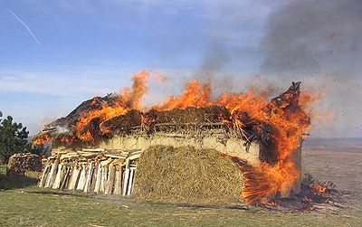 Recreation of a Cucuteni-Trypillian house burning; note the amount of extra fuel (straw and wood) added to the outside of the clay walls to increase the temperature needed for ceramic vitrification. ArhExp3 Arheoinvest.jpg