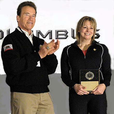 Schwarzenegger, pictured with 1987 world champion American Karyn Marshall, presenting awards at the USA Weightlifting Hall of Fame in 2011 in Columbus, Ohio