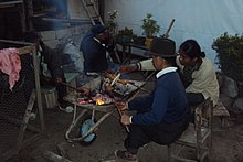 Indigenous people of the Otavalo people, roasting guinea pigs on charcoal. Asando Cuyes.jpg