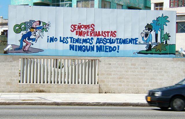 Cuban propaganda poster in Havana featuring a Cuban soldier addressing a threatening Uncle Sam. The translation reads: "Imperialist sirs, we have abso
