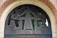 Carved wooden tympanum at St Francis Church, Bournville
