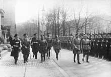 Werner von Blomberg inspects a parade in his honor on his birthday. Soldiers with Guns stand to attention.
