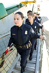 Officers board a ship using a gangway.
