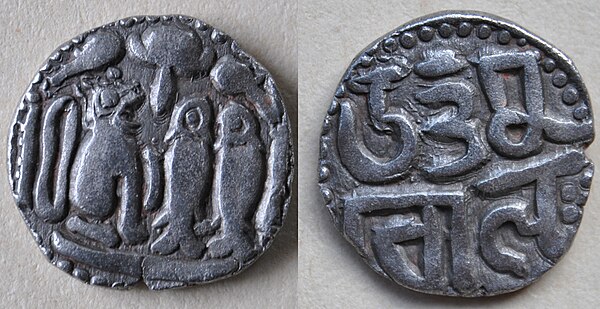 An early silver coin of Uttama Chola found in Sri Lanka showing the tiger emblem of the Chola and in Nagari script.