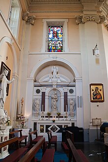 An altar of Our Lady on the left side of a church. The pews face towards the main altar. Clonmel Irishtown St. Mary's Church of the Assumption East Transept 2012 09 06.jpg