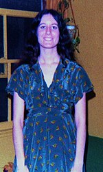 A young woman wearing a wrap dress. Disco dress 1970s.jpg