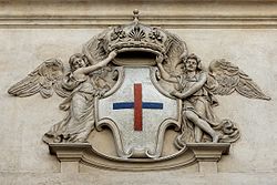 Stone shield of the Trinitarian Order on the facade of San Carlo alle Quattro Fontane (1638-1641) in Rome. Emblem Trinitarian Order Rome.jpg