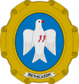 Escudo del municipio español de Benacazón: «En campo ovalado de azul celeste, una paloma blanca»