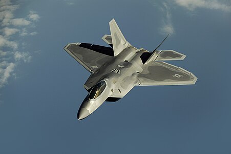 An F-22 Raptor flies over Kadena Air Base, Japan