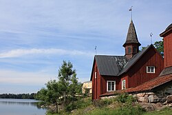 Fagervikin kirkko Bruksträsketin rannalla. Taustalla Fagervikin kartano.