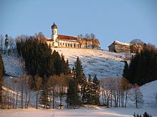 Gipfel des Hohen Peißenbergs mit Wallfahrtskirche und alter Schule im Winter