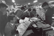 Journalists scanning through the paper (May 17, 1974)