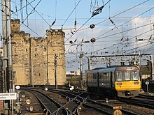 A Northern Rail Class 142 leaving Newcastle in 2009, Castle Keep is in the background