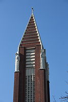 The bell-tower of the Église Saint-Antoine-de-Padoue. Two of the four statues of saints can be seen near the top.