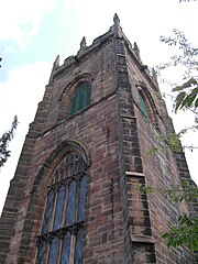 Exterior view of the western end of the church, showing large Perpendicular window.