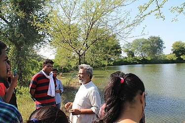 Rajendra Singh, founder of Tarun Bharat Sangh NGO explaining the use of a johad to the students of TERI University in Alwar district of Rajasthan Rajendra Singh interacting with Teri University Students.JPG