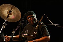 Percussionist Rashied Ali (pictured in 2007) augmented Coltrane's sound. Rashied Ali.jpg