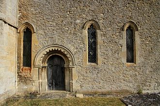 Part of the south wall of the chancel of St Faith's church, showing the 12th-century Norman priest's door and 14th-century Decorated Gothic windows Shellingford StFaith ChancelSSE.jpg