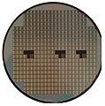 A silicon wafer; individual devices (VLSI in squares) are not usable until diced, wire-bonded, and packaged