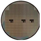 A silicon wafer holding many integrated circuit chips Silicon wafer.jpg