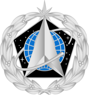 https://upload.wikimedia.org/wikipedia/commons/thumb/e/e2/Space_Staff_Identification_Badge.png/180px-Space_Staff_Identification_Badge.png