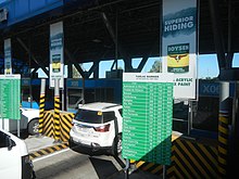 A car stopping at a tollbooth in Subic-Clark-Tarlac Expressway. Subic-Clark-Tarlac Expressway Toll Plaza - Tarlac Barrier 9.jpg