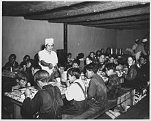 In Penasco, New Mexico, students paid about one cent daily for a hot meal made primarily of food from the surplus commodities program, prepared by cooks paid by the Works Progress Administration (1941). Taos County, New Mexico. The hot lunch, school at Penasco. Children pay about 1 cent daily for thi . . . - NARA - 521840.jpg