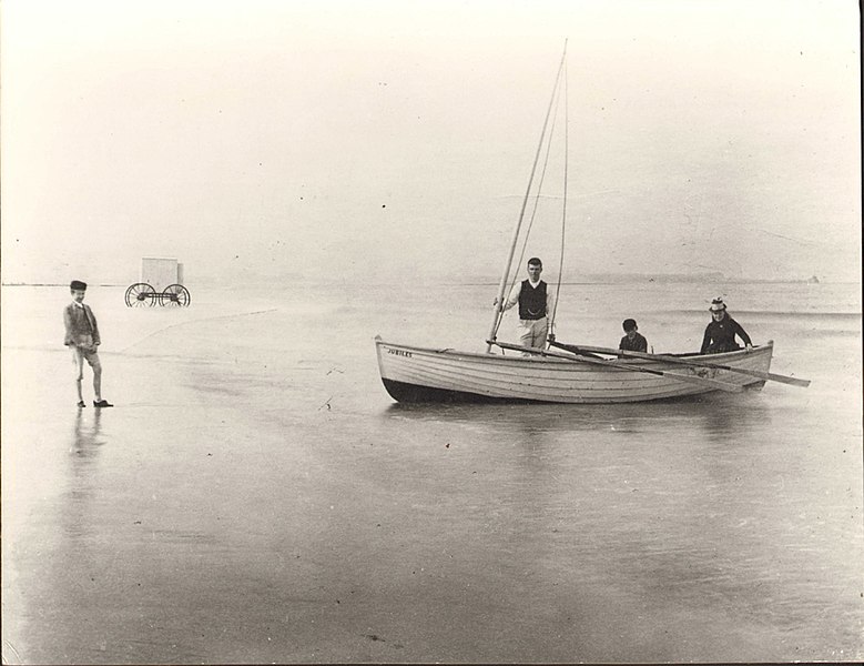 File:This image of the Seaton Carew shoreline shows three people in a small boat, with oars and a mast. The boy on the left is standing on the sand. (5981676980).jpg