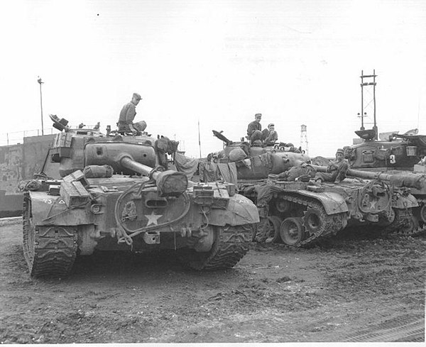 Pershing and Sherman tanks at the Pusan Docks, Korea.