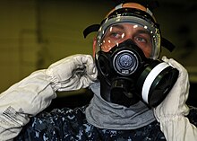A United States Navy sailor donning a MCU-2P protective mask during a chemical, biological, and radiological (CBR) drill aboard the USS George H.W. Bush (CVN-77). US Navy 100925-N-3374C-032 Yeoman Seaman Michael Barnes, assigned to the administration department of the aircraft carrier USS George H.W. Bush (CV.jpg