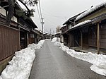 Street with traditional wooden houses in winter.