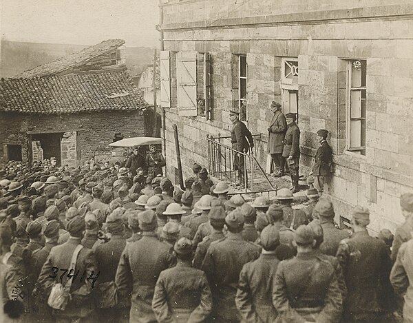 The commander of the 32nd Division, Major General William G. Haan, with Brigadier General Edwin B. Winans, congratulating doughboys of the 127th Regim