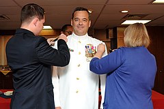 Vice Adm. Thomas H. Copeman III has his vice admiral shoulder boards placed on by his son and wife, July 19, 2012.