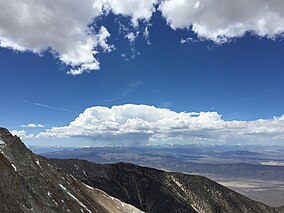 2015-05-03 13 38 12 View west toward developing thunderstorms above the Sierra Nevada mountains from about 12080 feet on the ridge northeast of Boundary Peak, Nevada.jpg
