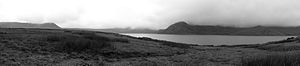 A black and white panoramic photograph of a lake in the Andes Mountains.jpeg