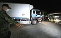 A policeman secures the arrival of a truck loaded with the China-donated CoronaVac vaccines at the Metropac Logistics in Marikina City.jpg