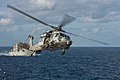 An MH-60S Sea Hawk helicopter assigned to Helicopter Sea Combat Squadron (HSC) 25 returns to the Military Sealift Command dry cargo and ammunition ship USNS Washington Chambers (T-AKE 11).JPG