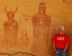 Feder stands in front of ancient pictographs at Sego Canyon in Utah. Archaeologist Ken Feder at Sego Canyon.JPG