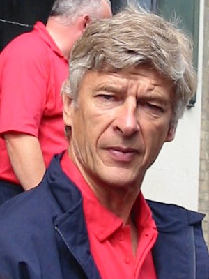 Arsenal manager Arsene Wenger and in the backg...